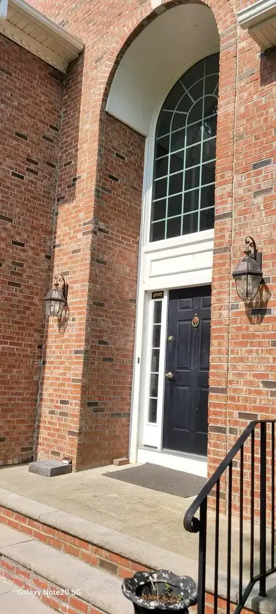 Clean brick entrance porch and front door area after professional power washing